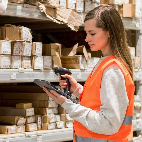 Worker scanning boxes in a warehouse